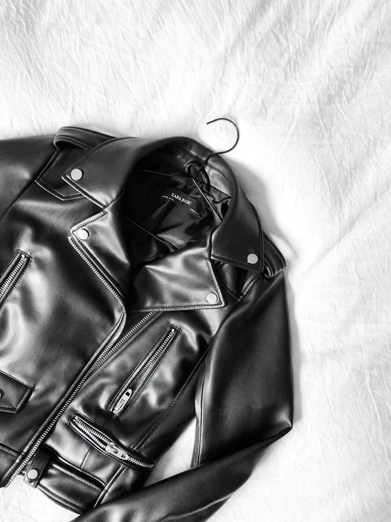 A black leather jacket on a hanger