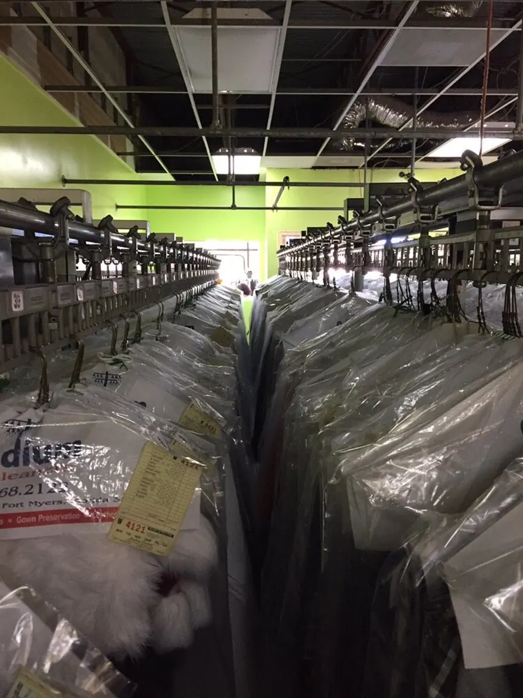 Bagged garments on the conveyor at a Stadium Dry Cleaners plant
