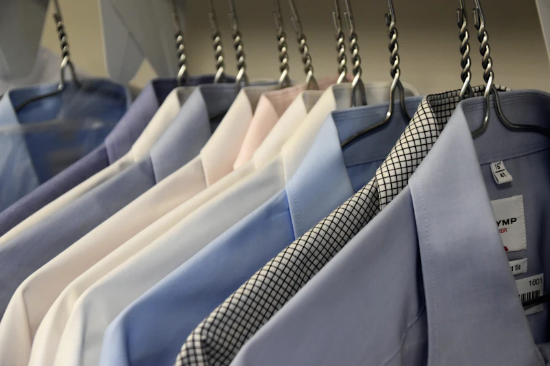 Freshly cleaned shirts and suit jackets on a rack