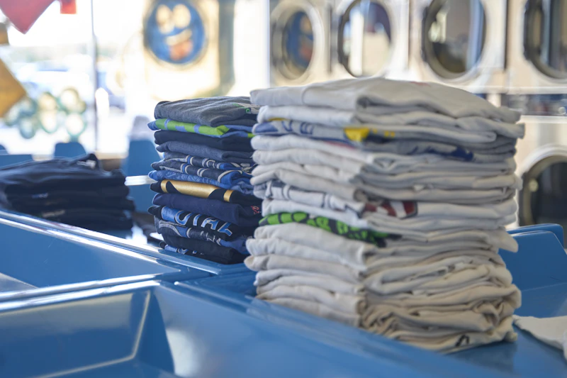 Neatly folded stacks of clean shirts
